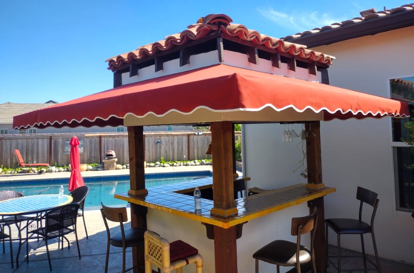 First slide, fabric awning around a residential poolside bar installation by Goodwin-Cole.